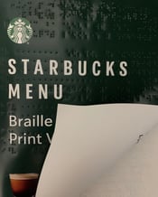 Starbucks menu in print/braille with a green branded cover